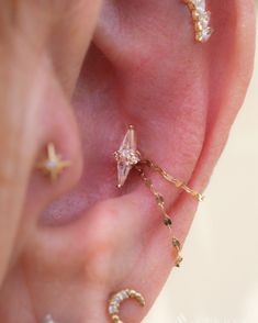 an ear with three different types of piercings on it