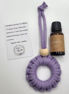 an item that is on the table next to a bottle of essential oils and a tag