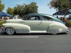 an antique car parked in a parking lot