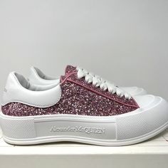 Alexander McQueen Women's Plimsol Deck Sneakers  100% Original & Authentic Guaranteed! Color: White Pink Glitter   Size: 10 US / 40 EU  Style Code: 676687 W4RN3 5686 Brand New In Box With Original Spare Laces  *Missing Box Label* Glitter low-top enhanced with leather heel patches. Canvas upper leather Tab Almond toe Lace-up vamp Rubber sole Made in Italy All our items are 100% Authentic Guaranteed  Item pictured is item being sold. Please review all pictures carefully before purchasing. Please feel free to message me with any questions!International Buyers: Please send us a message to inquire about shipping options to your country. Glitter Sneakers For Spring Streetwear, Spring Glitter Sneakers For Streetwear, Glitter Accent Sneakers For Streetwear With Round Toe, Glitter Accented Sneakers For Streetwear With Round Toe, Glitter Accents Sneakers For Streetwear With Round Toe, Trendy Glitter Print Sneakers For Spring, Sporty Glitter Sneakers For Spring, Casual High-top Sparkling Sneakers, Pink Glitter Accent Sneakers For Spring