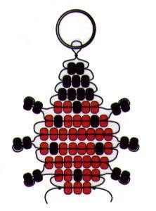 a red and black beaded ornament hanging from a metal hook on a white background