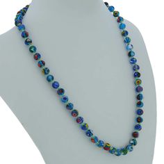 Add a touch of classic Venetian style to your outfit with this elegant Murano millefiori necklace. Centuries-old Murano glass technique perfected by Italian master craftsmen is used to create colorful mosaic effect that is fun and trendy, yet classic and timeless. This is a unique necklace that will add Venetian chic to your jewelry collection and will brighten up your look and your day. Measurements: Each necklace measures 24 inches in length and comes with an attractive velvet pouch and a cert Turquoise Round Glass Necklaces, Blue Round Glass Necklaces, Blue Glass Round Necklaces, Blue Single Strand Murano Glass Beaded Necklace, Blue Single Strand Murano Glass Necklace, Blue Murano Glass Single Strand Necklace, Elegant Blue Murano Glass Necklace, Colorful Mosaic, Blue Mosaic