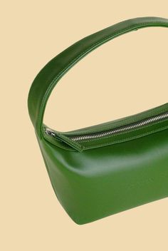 The Amelia Mini Bag is your perfect go-to bag that never compromises style (or the environment!). Made from semi-patent green cactus leather, the Amelia Mini Bag features a zipper closure, a blind embossed logo and an interior slip pocket. Product Info: Height: 25.4cm (with strap)Length: 20cmStrap Drop: 15.25cmWidth: 8.89cm All Santos products are handmade to order in the US. In collaboration with Desserto, our plant-based leather is crafted from cactus fibers and made in Mexico. Our lining is m Green Rectangular Baguette Bag For Office, Elegant Green Baguette Bag With Detachable Handle, Elegant Green Baguette Bag For Office, Elegant Green Rectangular Baguette Bag, Modern Green Leather Baguette Bag, Luxury Green Baguette Bag For Shopping, Elegant Green Handheld Baguette Bag, Elegant Green Baguette Bag For Formal Occasions, Green Modern Baguette Bag With Detachable Handle