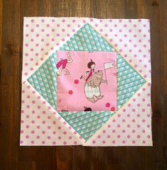 a pink and green patchwork piece with a girl on it's back in the center