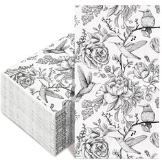 a stack of napkins with flowers and birds on them