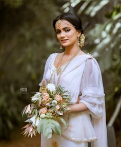 a woman in a white dress holding a bouquet