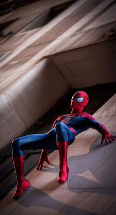 the spider man is posing on his knees