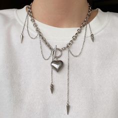 This necklace is made in a grunge style. It consists of two types of chains and pendants. The necklace is made of stainless steel, so it won't tarnish and will maintain its flawless appearance for a long time. This statement piece will add a bold touch to your look. It is also a perfect gift option. Material: Stainless Steel. Finish: Rhodium plated. Heart Pendant Size: 2.5*2.5 cm. Length 44cm. 🔸more from us🔸 https://www.etsy.com/shop/DoraJewelryAccessory Cheap Punk Necklaces With Adjustable Chain, Grunge Heart-shaped Metal Necklace, Punk Style Heart-shaped Metal Jewelry, Emo Heart Pendant Metal Necklaces, Emo Heart Pendant Metal Necklace, Grunge Clavicle Chain Necklace As Gift, Silver Chain Necklace In Emo Style, Punk Jewelry For Valentine's Day Concert, Y2k Style Chain Necklace For Gift