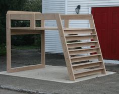 a wooden ladder sitting on top of a sidewalk next to a white building with a red door