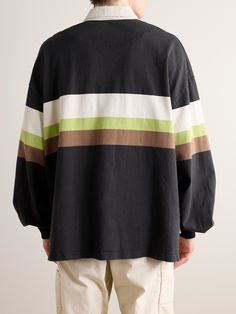 KAPITAL has made a name reiterating Western style through a Japanese lens. This rugby-style shirt is cut from striped cotton-jersey and has an adjustable toggle at the stepped hem. Cotton Tops With Vertical Stripes For Fall, Casual Black Tops With Striped Cuffs, Cotton Tops With Signature Stripes For Fall, Fall Cotton Tops With Signature Stripes, Long Sleeve Cotton Tops With Vertical Stripes, Sporty Long Sleeve Tops With Signature Stripes, Striped Tops For Streetwear, Black Sporty Tops With Striped Collar, Black Top With Horizontal Stripes And Relaxed Fit