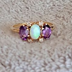 10k Gold Ring With Opel, Diamonds, And Amethyst Stones Opal Center, Flanked By Two Matching Amethyst Stones, And Four Diamonds Surrounding The Opal. Size 6 1/4 Ring Was Recently Serviced (Prongs Are Tight). Elegant Purple Opal Ring For Anniversary, Elegant Purple Opal Anniversary Ring, Heirloom Multi-stone Purple Amethyst Ring, 14k Gold Multi-stone Purple Amethyst Ring, Purple Three Stone Fine Jewelry, 10k Gold Ring, Amethyst Stones, Amethyst Stone, 10k Gold