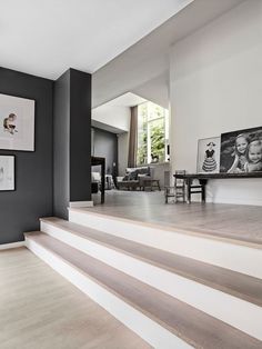 the stairs in this modern home are painted black and white