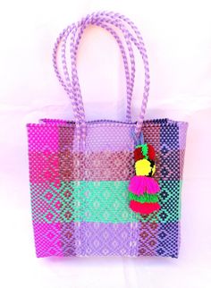 This woven bag is made of thick and resistant plastic. Large size. In Mexico it is used to make purchases and that's is called 'Market bag' either 'The grocery bag'. The measurement could vary from bag to bag, because they are handmade, but these bags have the following measures aproximately : wide 13 "(33cm)  high 12" - 11 1/4" (31cm-29cm) deep 5" - 4 1/2" (13cm-11.5cm) long handles 10" -9"  (25cm-22cm) This bag come with a tye dye multicolor pompom The colors could vary slightly from the pictu Colorful Handwoven Tote Bag, Pink Rectangular Crochet Bag For Market, Square Multicolor Handwoven Crochet Bag, Fair Trade Tote Beach Bag For Shopping, Multicolor Handwoven Crochet Tote Bag, Fair Trade Multicolor Beach Bag For Travel, Green Square Handwoven Straw Bag, Eco-friendly Multicolor Handwoven Beach Bag, Green Handwoven Square Straw Bag