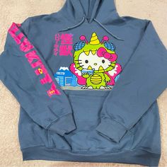 Brand New Never Used Says “Hello Kitty Monster” In Japanese Comes From A Smoke And Pet Free Home! I Also Have More Sanrio Items On My Page So Feel Free To Check It Out! Blue Cartoon Print Hoodie For Streetwear, Kawaii Blue Cotton Hoodie, Blue Cotton Kawaii Hoodie, Blue Cartoon Print Sweatshirt For Streetwear, Casual Hello Kitty Hooded Sweatshirt, Casual Hooded Hello Kitty Sweatshirt, Casual Hooded Sweatshirt With Hello Kitty Print, Blue Harajuku Cotton Sweatshirt, Blue Cotton Harajuku Sweatshirt