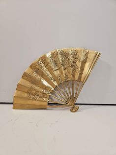 a gold fan sitting on top of a white counter