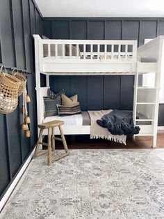 a white bunk bed sitting in a bedroom next to a rug