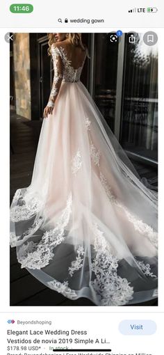 a woman in a wedding dress standing on a porch with her back to the camera