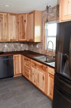 a kitchen with wooden cabinets and black appliances