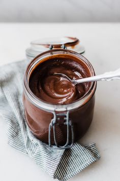 chocolate spread in a glass jar with a spoon