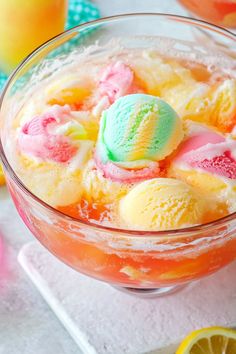 a bowl filled with ice cream next to sliced lemons