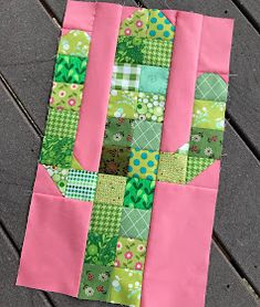 a pink and green patchwork piece on the ground