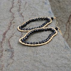 The abstract shapes in our freestyle collection are each completely unique.- Black spinel gemstones- 2 1/2" long- French hooks- 14k gold plated .925 fine Italian sterling silver- Made in the USA in our NYC studio- Packaged in a gift box- Free shipping on US ordersHandmade to last. Our unique gold plating technique makes our jewelry tarnish resistant. The nature of natural gemstones makes each style one-of-a-kind. Modern Black Spinel Jewelry For Gifts, Handmade Modern 14k Gold Filled Jewelry, Elegant Freeform Wire Wrapped Jewelry, Elegant Freeform Earrings For Gifts, Elegant Handmade Freeform Earrings, Elegant Freeform Gemstone Jewelry, Gold Freeform Earrings As Gift, Gold Freeform Earrings For Gift, Modern Wire Wrapped Jewelry For Party