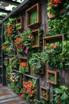 a wooden wall covered in plants and flowers