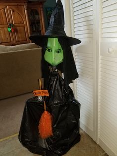 a plastic bag with a witch's head and broom sticking out of it