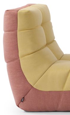 a pink and yellow chair sitting on top of a white floor