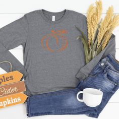 Our shirts are handmade in Ohio by hand with love and care one at a time. We hope you will find a shirt that will inspire you or someone else. DESCRIPTION: Pumpkin Shirt, Fall Long Sleeve Shirts, Autumn Shirt, Fall Shirt Women, Fall Pumpkin Shirt, Fall Long Sleeve T Shirt, Pumpkin Long Sleeve, Autumn Long Sleeve, Pumpkin Long Sleeve tshirt, Pumpkin Longsleeve, Pumpkin Shirt Women, Fall Shirts This cute long sleeve pumpkin shirt is perfect for women for this Holiday Season! Show off your holiday Fall Graphic Tee Shirt With Long Sleeves, Long Sleeve Graphic Tee For Fall, Graphic Tee Long Sleeve Shirt For Fall, Fall Cotton Shirt In Orange, Orange Cotton Shirt For Fall, Casual Screen Print Shirt For Fall, Orange Screen Print Top For Fall, Orange Relaxed Fit Tops For Fall, Orange Shirt With Graphic Print For Fall