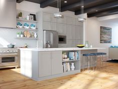 a modern kitchen with white cabinets and stainless steel appliances is pictured in this image, the island has two blue stools on it