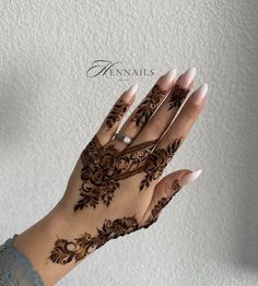 a woman's hand with hennap on it and the words hennails written in arabic