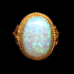 A fabulous oval opal Ring set in an 18ct Gold and Silver rope edge setting and Shank. This Beautiful ring has been designed and hand-made by a British professional Jewellery craftsman. The oval-created Opal stone shines with all the iridescent colours of the rainbow. A truly magnificent ring that can be worn with so many outfits. Classic Oval Opal Ring Collectible, Heirloom Oval Opal Ring Collectible, Handmade Oval Opal Ring In Yellow Gold, Oval Opal Ring, Vintage Clip Earrings, Professional Jewelry, Opal Stone, Opal Ring, Beautiful Ring