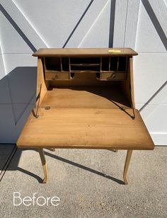 an old wooden desk with some drawers on it