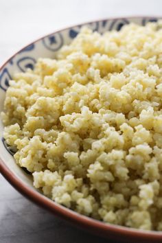 a bowl filled with rice on top of a table