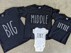 three black onesuits with white letters that say,'big middle and tiny '