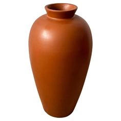 a large brown vase sitting on top of a white table