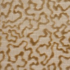 an upholstered fabric with brown and tan swirls on the top of it