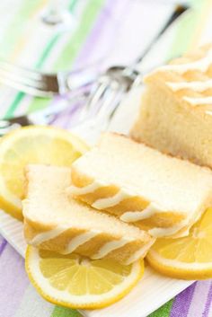 sliced lemon bread sitting on top of a white plate next to slices of lemons