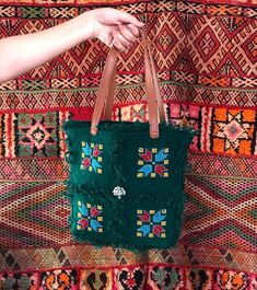 this handbag makes your style more unique and special because it's handmade 100% with much love... I made it with my mom by using  hand-woven tissue by the women of Artissma Foundation which means :"Art du Tissage Marocain".  PS: (Don't forget to check our story) https://www.etsy.com/your/shops/artissma/tools/listings So, this bag is made by woolen threads with shoulder straps made by genuine leather, and decorated by different Berber symbols inspired by nature and Moroccan culture, with some si Green Bohemian Handheld Bag, Brown Bohemian Cotton Shoulder Bag, Bohemian Multicolor Embroidery Bags As Gifts, Bohemian Handheld Bag With Leather Handles, Bohemian Handheld Bags With Leather Handles, Handmade Green Tote Canvas Bag, Bohemian Embroidered Bag For Everyday Use, Handmade Hippie Rectangular Bag, Bohemian Crochet Bag With Leather Handles For Daily Use