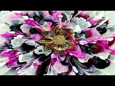 a close up view of a flower with purple and white petals