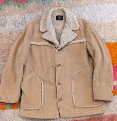 "Fleece lined 1970's jacket with soft corduroy outer fabric. Two large front pockets and button front closure.  LABEL Brad Whitney, Carmel by the Sea MATERIALS: Sherpa fleece lining & soft corduroy  Size tag: none Best Fit: XL/ XXL Era: 70s Chest: 24\" Waist 24\" Hem: 23.5\" Shoulder to shoulder: 21\" Sleeve: 26\" Total length: 32\" [CONDITION] Very good  Guide to Condition of Vintage Clothes Mint: Beautiful and perfect. Possibly never worn. Excellent: Little visible wear, lightly worn. Very Good: Normal wear for the age of the garment. Good: A few obvious visible flaws. Garment construction is sound and wearable. Please feel free to contact me with any questions or for additional photos.  -------------------------------------------- -All measurements are taken flat and in inches. Please e Beige Corduroy Outerwear With Buttons, Retro Corduroy Winter Outerwear, Retro Corduroy Outerwear For Winter, Vintage Beige Cotton Outerwear, Retro Corduroy Outerwear With Corduroy Collar, Vintage Corduroy Outerwear With Pockets, Vintage Corduroy Outerwear For Fall, Vintage Outerwear With Corduroy Collar For Fall, Vintage Brown Corduroy Outerwear