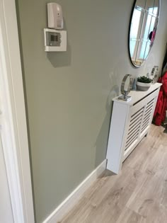 there is a white radiator in the corner of this room with gray walls