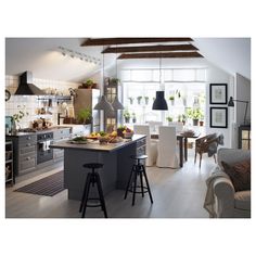 an open kitchen and living room area with stools