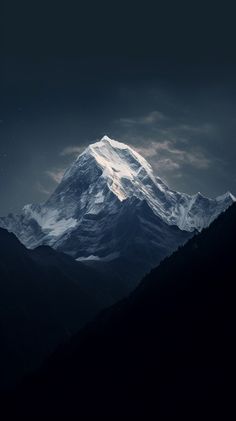 the top of a mountain with dark clouds in the sky and stars above it, as seen from below