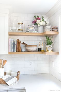 the shelves in the kitchen are filled with dishes and cooking utensils on them