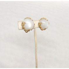 This is part of Chairish’s Costume Jewelry assortment.  1950s goldtone round white "moonglow" faux-moonstone with filigree surround clip back earrings. Marked "Napier©" Measure: 1 inch long by 1 inch wide. Condition: Very good; some light wear to goldtone. Vintage Round Clip-on Earrings With Cabochon, Vintage Round Cabochon Clip-on Earrings, Vintage White Round Clip-on Earrings, White Vintage Earrings, White Vintage Round Earrings, White Vintage Clip-on Earrings For Formal Events, Vintage White Clip-on Earrings For Anniversary, White Vintage Clip-on Earrings For Anniversary, Retro White Clip-on Jewelry