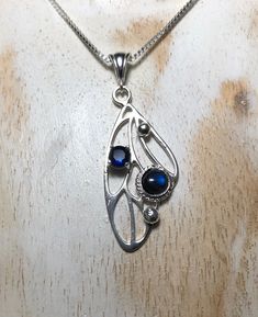 I've fabricated a bohemian fakery wing style necklace to which I simply adore. This piece is made entirely in sterling silver with a 6mm Cabochon, of your choosing, and comes with a 5mm sapphire. I like Fae whimsical pieces and will be adding more to my collection soon. Each one I make will vary slightly due to the handmade quality and integrity and care of each one. These are made by me, at my bench studio. It will be a large statement necklace, at approximately 1,75 inches in length and approx Bohemian Sterling Silver Teardrop Pendant Necklaces, Silver Bohemian Birthstone Necklace, Bohemian Sterling Silver Birthstone Jewelry, Bohemian Sterling Silver Oval Pendant Necklace, Silver Teardrop Necklaces With Unique Variations, Sterling Silver Teardrop Jewelry With Unique Variations, Artisan Sterling Silver Necklace With Birthstone, Artisan Silver Birthstone Necklace, Artisan Silver Necklace With Birthstone