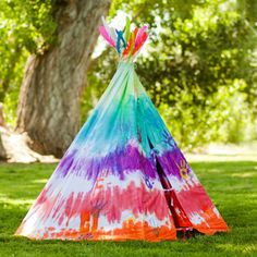 a colorful teepee sitting in the grass