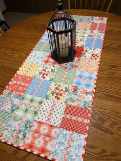 a table runner with a birdcage on it